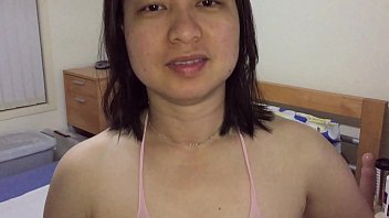 Asian MILF Teases in Pink Stockings for XVideos Fans