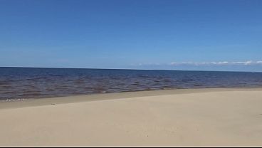 Sultry Mature Woman Flaunts Her Sheer-wrapped Curves On The Sandy Shore